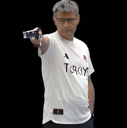 a man wearing a white t-shirt that says turkey is pointing a gun