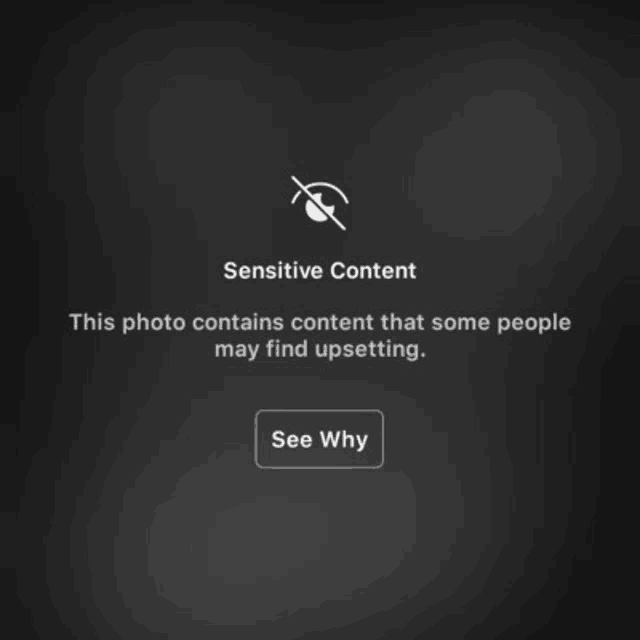 a black screen with a sensitive content message and a see why button