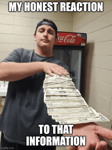 a man holds a stack of money in front of a coca cola fridge