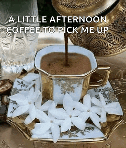 a little afternoon coffee to pick me up is poured into a cup surrounded by white flowers