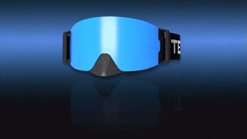 a pair of blue ski goggles with the letter t on the strap