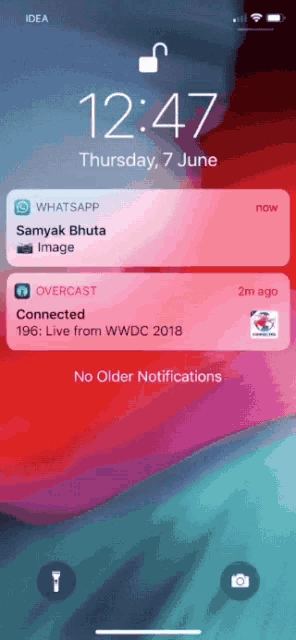 a phone screen shows a notification for whatsapp