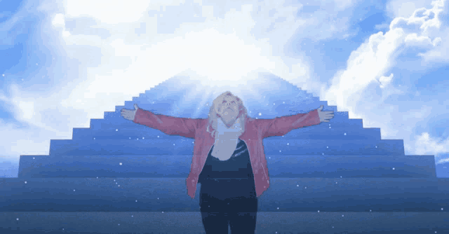 a woman in a pink jacket is standing in front of a blue staircase with her arms outstretched