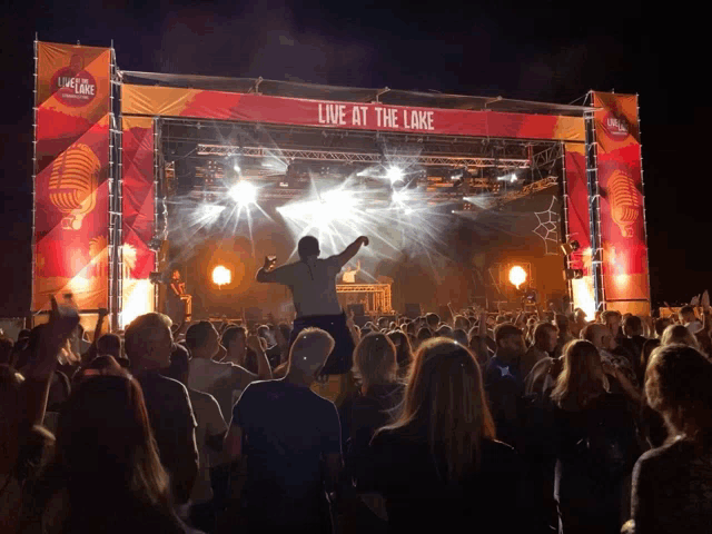 a crowd of people are watching a live at the lake event