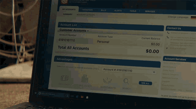 a laptop screen shows a customer accounts page with a current balance of $ 0.00