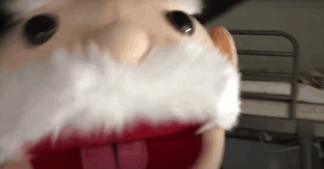 a close up of a puppet with a beard and red lips