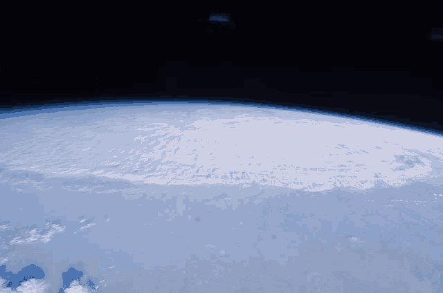 a view of the earth from space with a few clouds on it