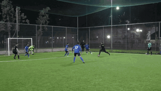 a group of soccer players are playing on a field and one player has the number 17 on his back