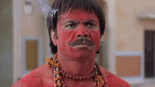 a man with red paint on his face and mustache is wearing a necklace and smoking a cigarette .