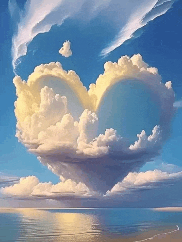 a cloud in the shape of a heart is floating over the ocean