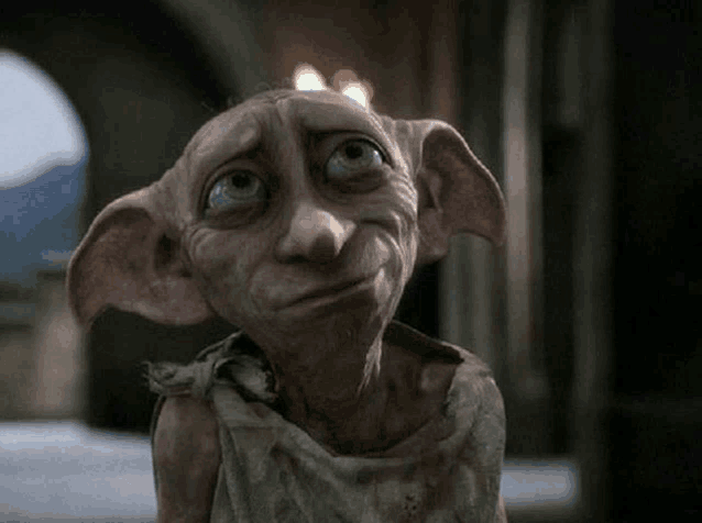 a dobby from harry potter is looking at the camera with a sad look on his face .