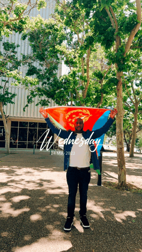 a man holding an ethiopian flag with the date wednesday