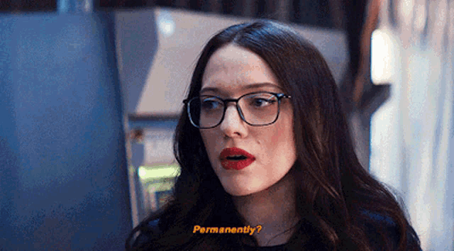 a woman wearing glasses and red lipstick is asking permanently