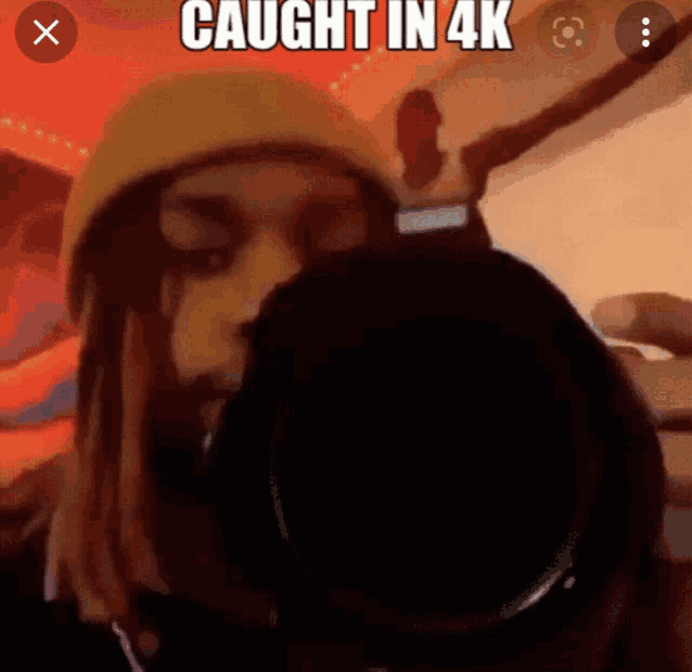 a person taking a picture with the words caught in 4k below them