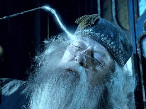 a man with glasses and a beard is holding a wand