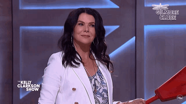 a woman on a kelly clarkson show holding a red bucket