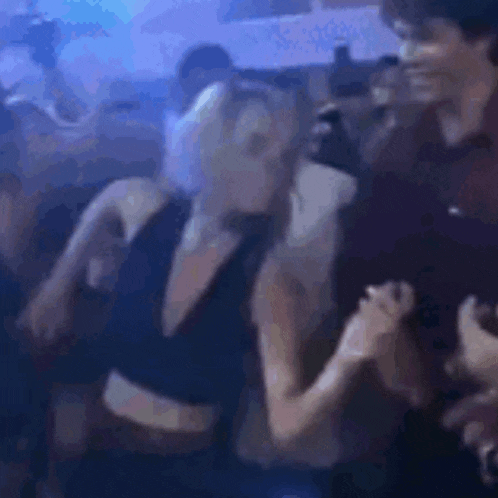 a man and a woman are dancing in a nightclub .