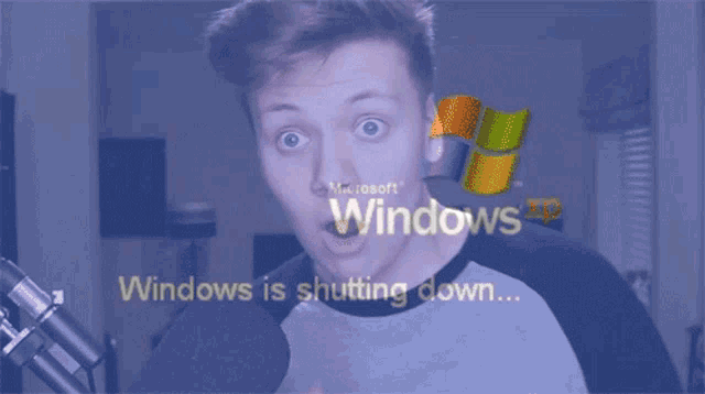 a man with a surprised look on his face is looking at a screen that says windows is shutting down