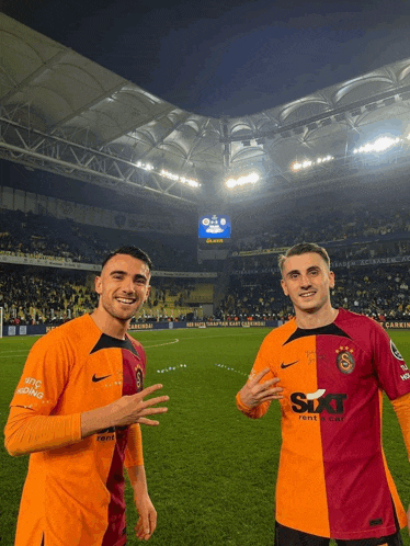 two soccer players one wearing a sixt rent a car jersey pose for a picture