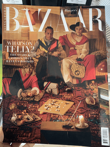 a harper 's bazaar magazine with a painting of people on the cover