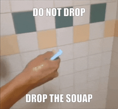 a hand is holding a sponge in front of a tiled wall with the words " do not drop drop the souap "