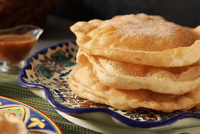 a plate of food with a stack of pancakes on top