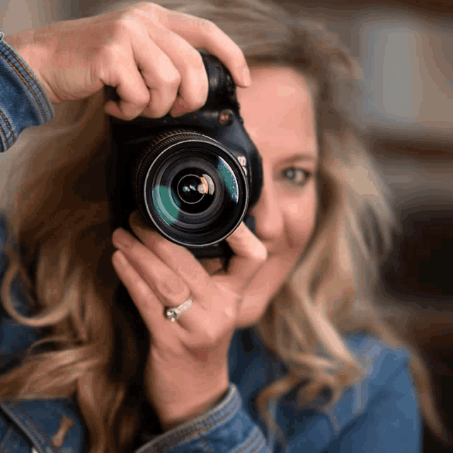 a woman is taking a picture of herself with a camera