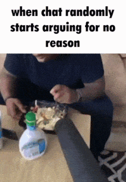 a man is sitting at a table with a bowl of food and a bottle of laundry detergent on the table