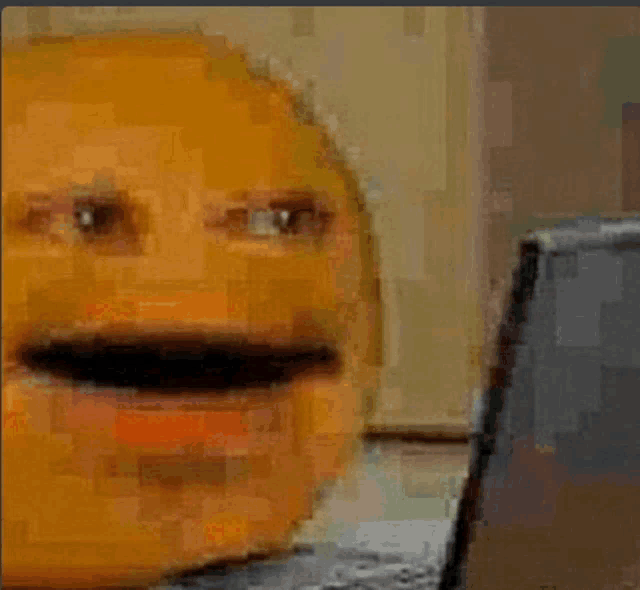 a pixelated image of a person 's face with a laptop in the background .