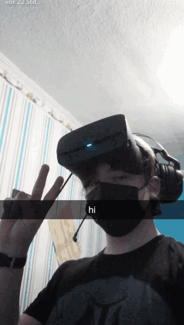 a person wearing a virtual reality headset and a mask says hi