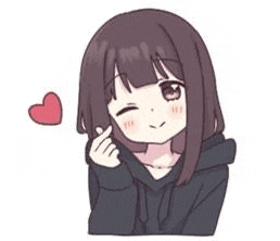 a girl in a black hoodie is making a heart with her finger .