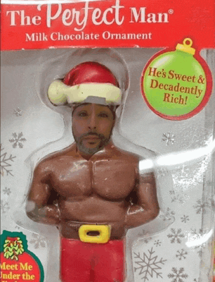 a perfect man milk chocolate ornament with a santa hat on his head