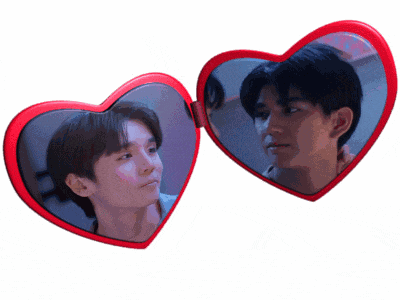 two red heart shaped mirrors with a man 's face on them