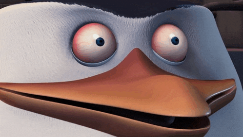 a close up of a cartoon penguin 's face with big red eyes