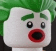 a close up of a lego joker head with green hair and red lips .