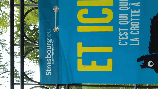 a blue sign with yellow letters that says etici