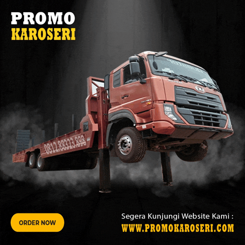 a red truck is sitting on a lift with the words promo karoseri above it