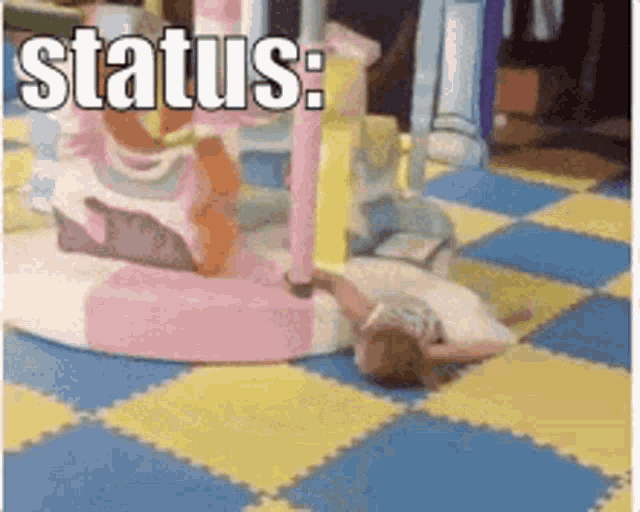 a little girl is laying on the floor in a playground with the words status :