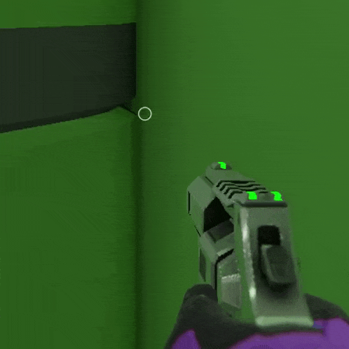 a person is holding a gun in front of a green wall while wearing purple gloves .