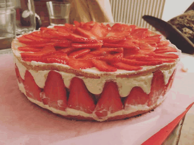 a cake with strawberries and white frosting on top