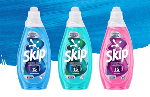 three bottles of skip laundry detergent are lined up