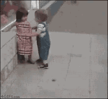 a girl in a red dress is pushing a boy in a blue shirt in a 4gifs.com image