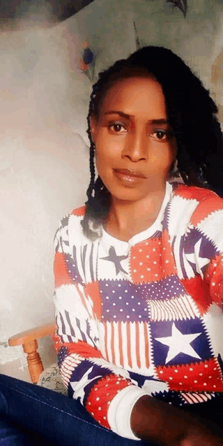 a woman is wearing a red white and blue sweater with stars on it