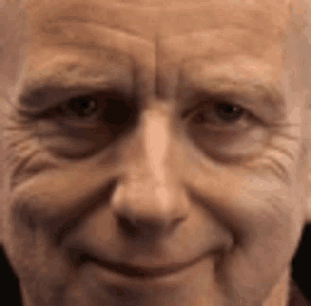 a close up of an older man 's face smiling .