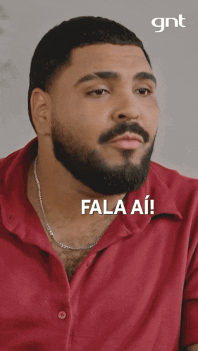 a man with a beard is laughing with the words fala ai on the bottom right