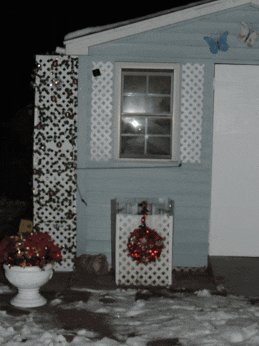 a house with a window and a wreath on the door