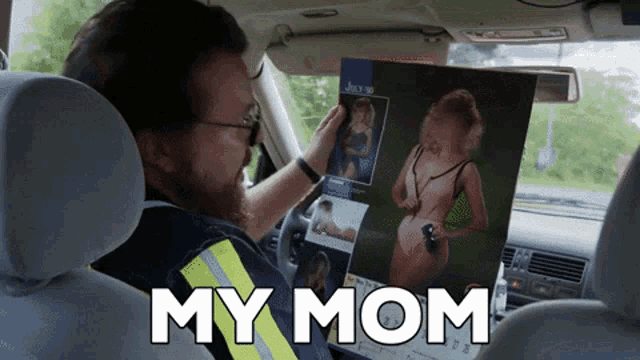 a man sitting in a car holding a picture of a woman and the words " my mom " above him