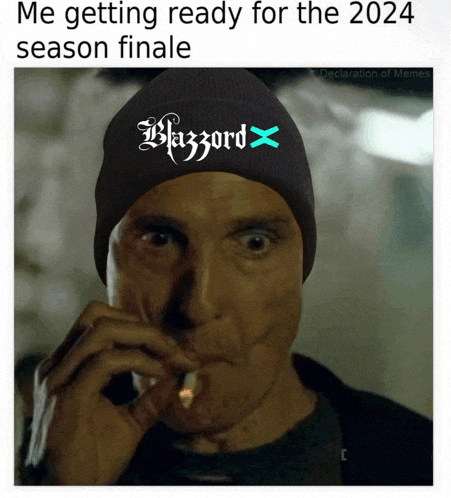 a man smoking a cigarette wearing a beanie that says blizzard on it