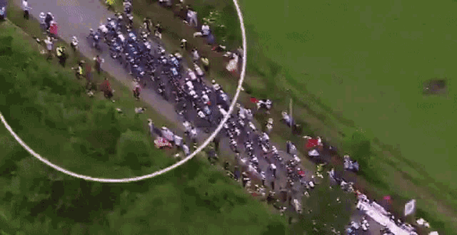 an aerial view of a group of people riding bicycles on a road with the word joy written on the ground