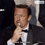 a man in a tuxedo and bow tie is holding a pen in his mouth and says " bond james bond "